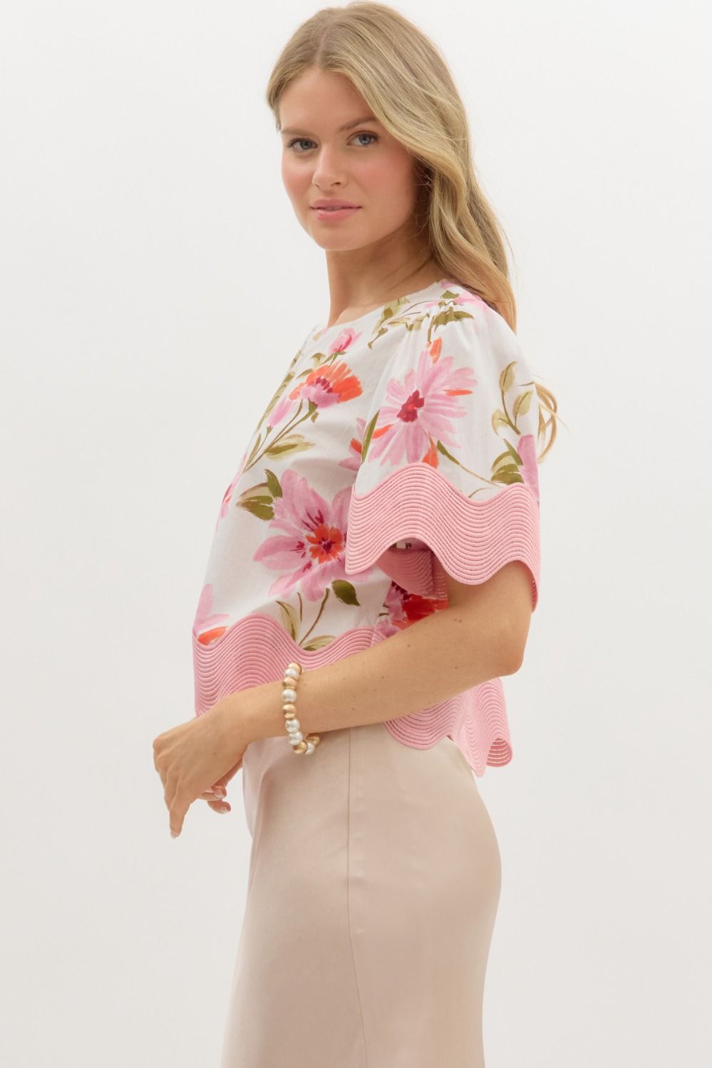 Women's cream and pink floral top with scalloped trim by Entro showing side view