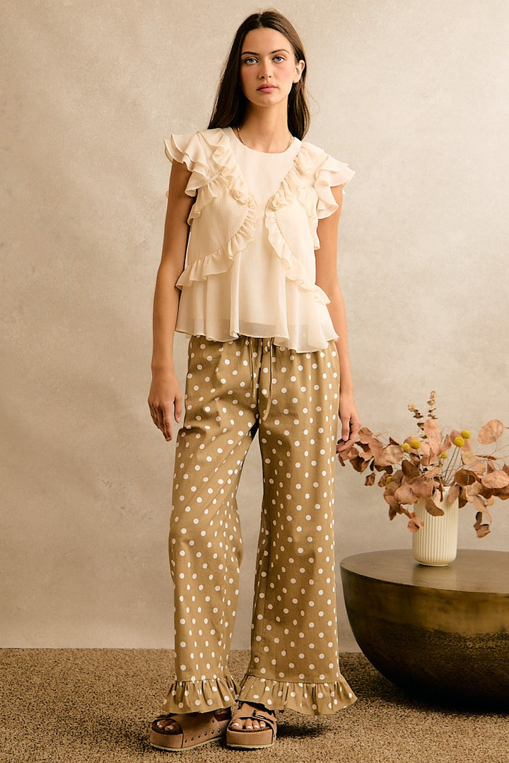 Cream chiffon top with ruffle details and a crew neckline