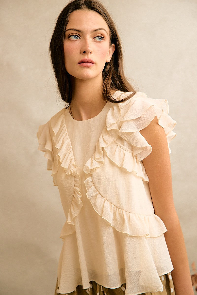 Cream chiffon top with ruffle details and ruffle capped sleeves
