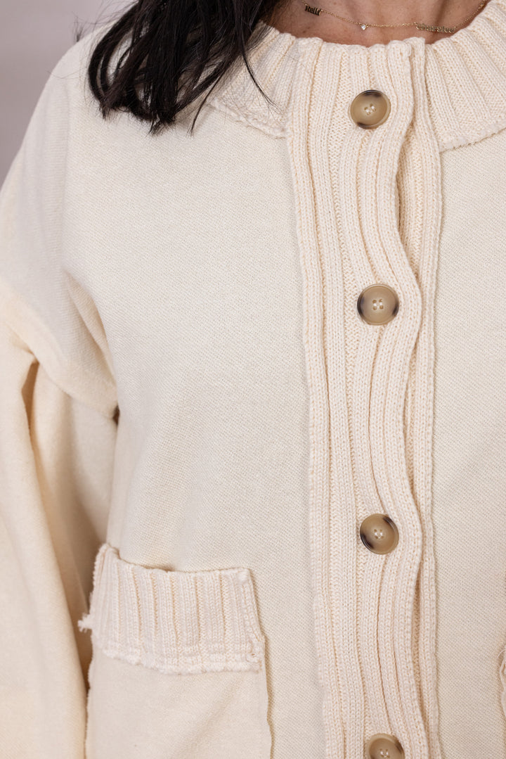 Women's ecru terry knit button front cardigan with textured ribbed knit trim by Entro showing button front closures