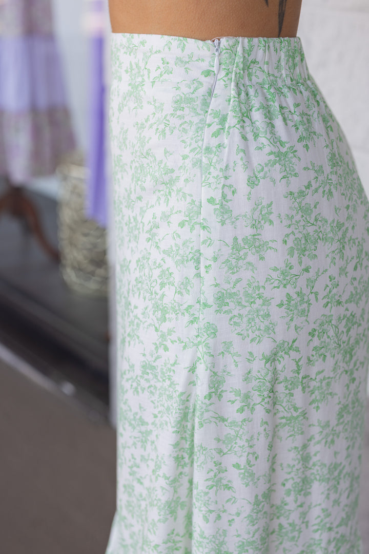 cream ruffle tiered midi skirt with green floral print side zipper closure