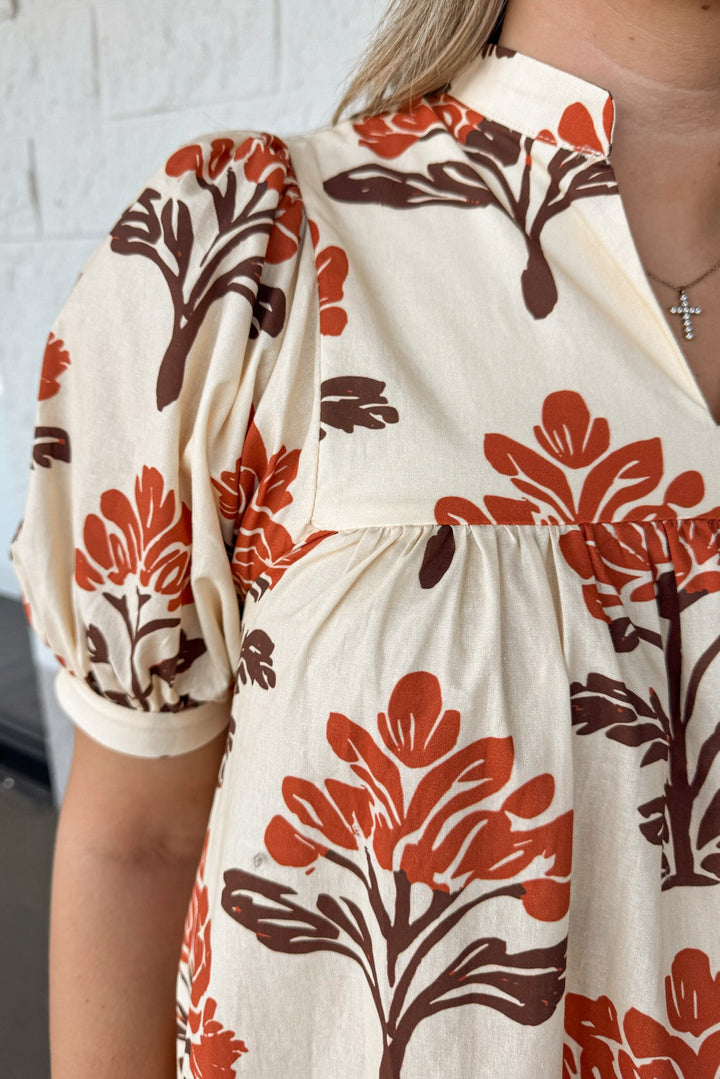 cream with orange and brown floral print puff sleeve v neckline poplin midi dress