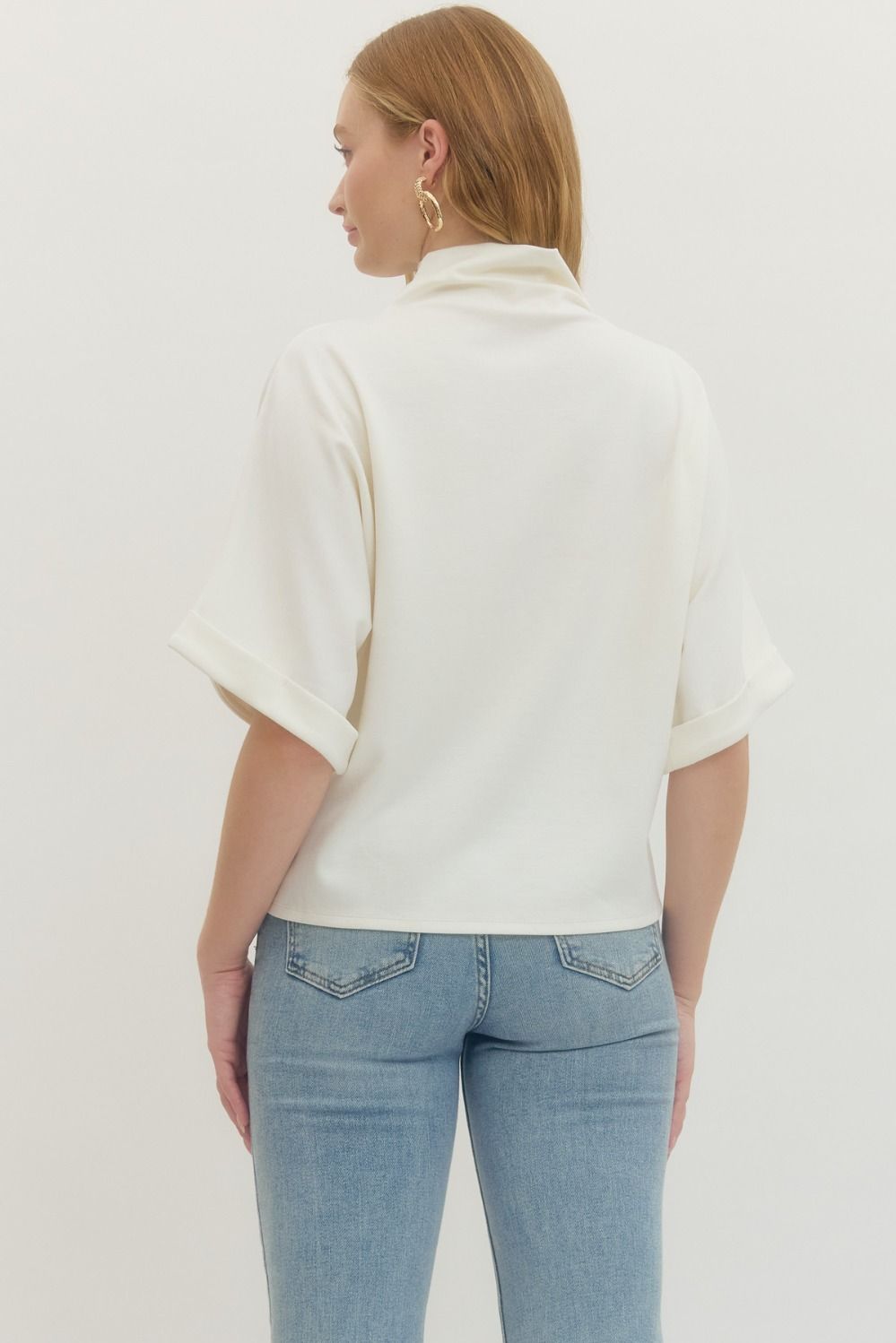 Women's cream scuba knit top with mock neck and dolman sleeves showing full back view