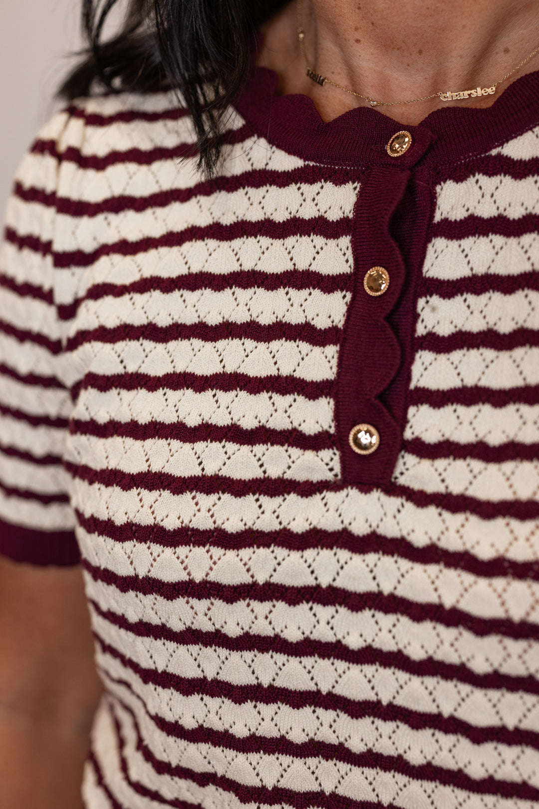 Women's burgundy and cream striped knit top with scalloped trim by Entro showing button details
