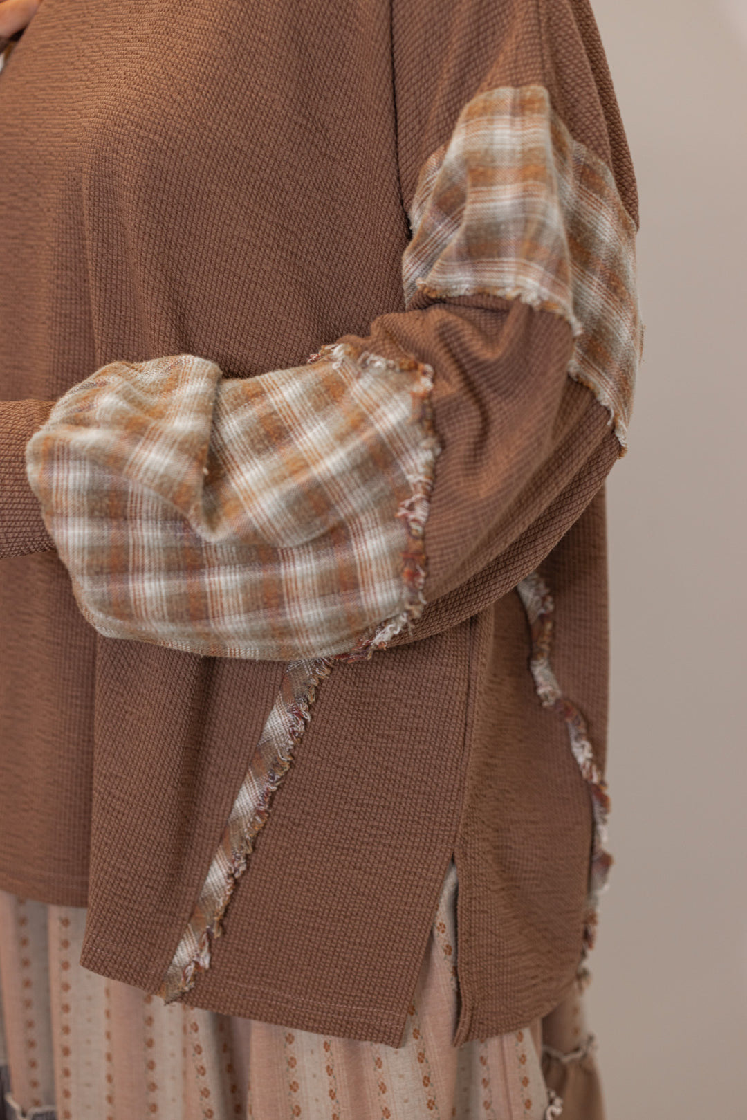 women's Brown textured knit top with plaid trimmed sleeves 