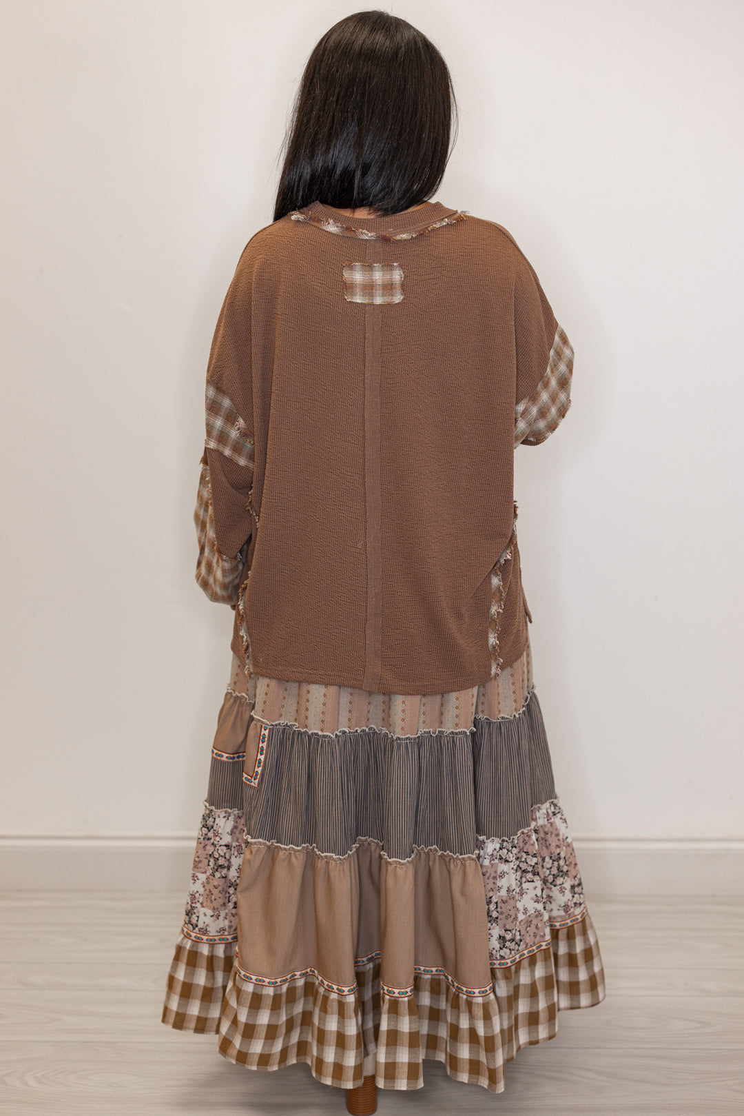 back view of Women's mocha brown knit long sleeve top with plaid detailing 