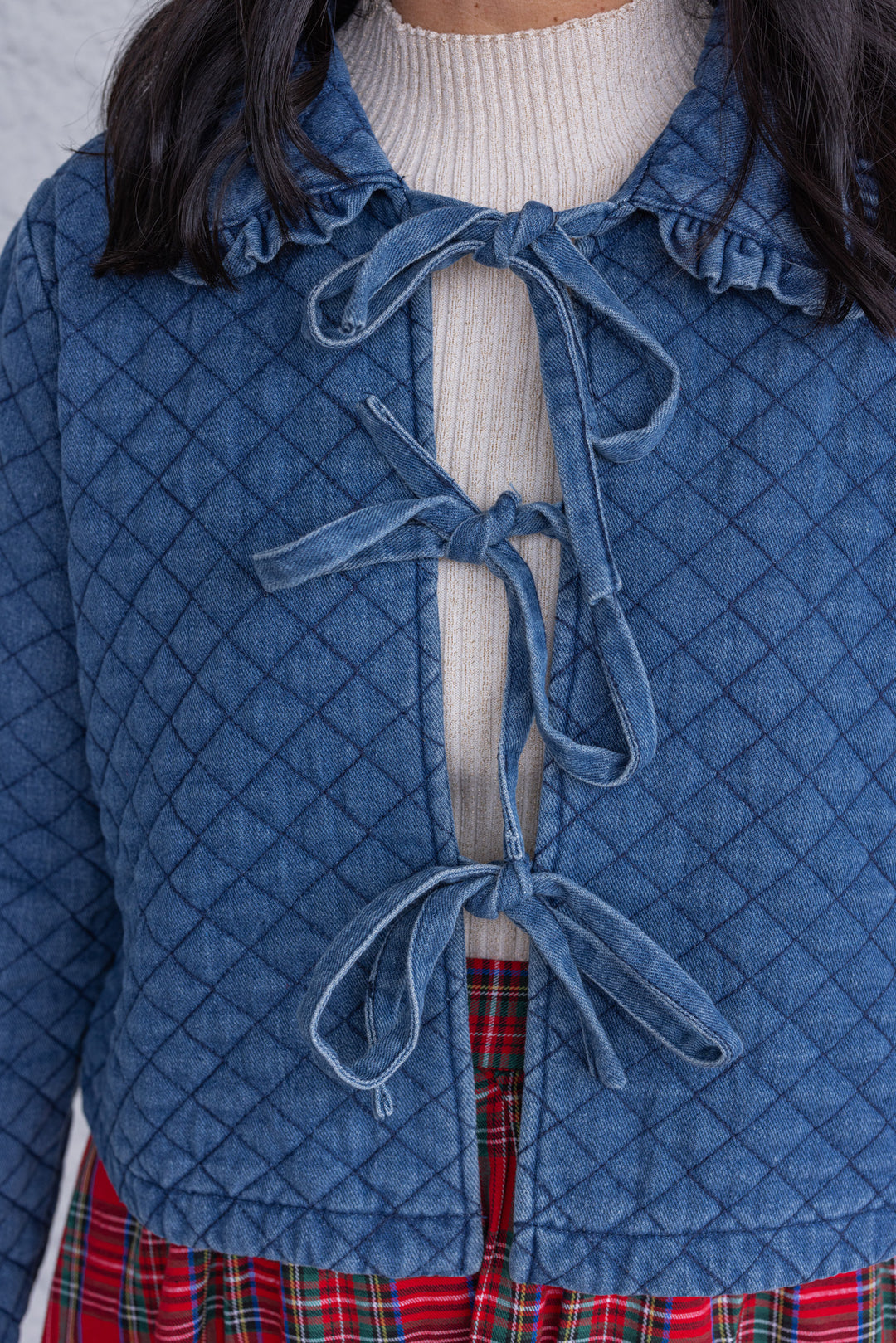 Women's blue denim quilted jacket with bow tie front closure by She + Sky showing up close bodice view