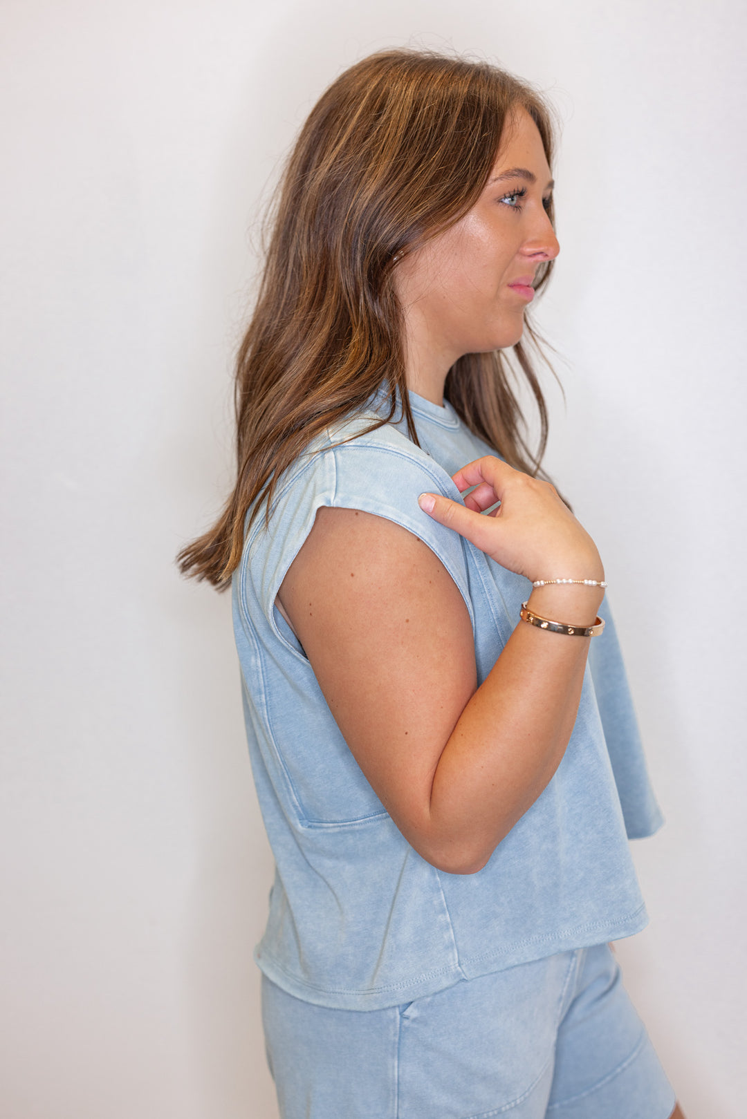 Women's mineral washed utility blue knit sleeveless top by Rae Mode showing side view