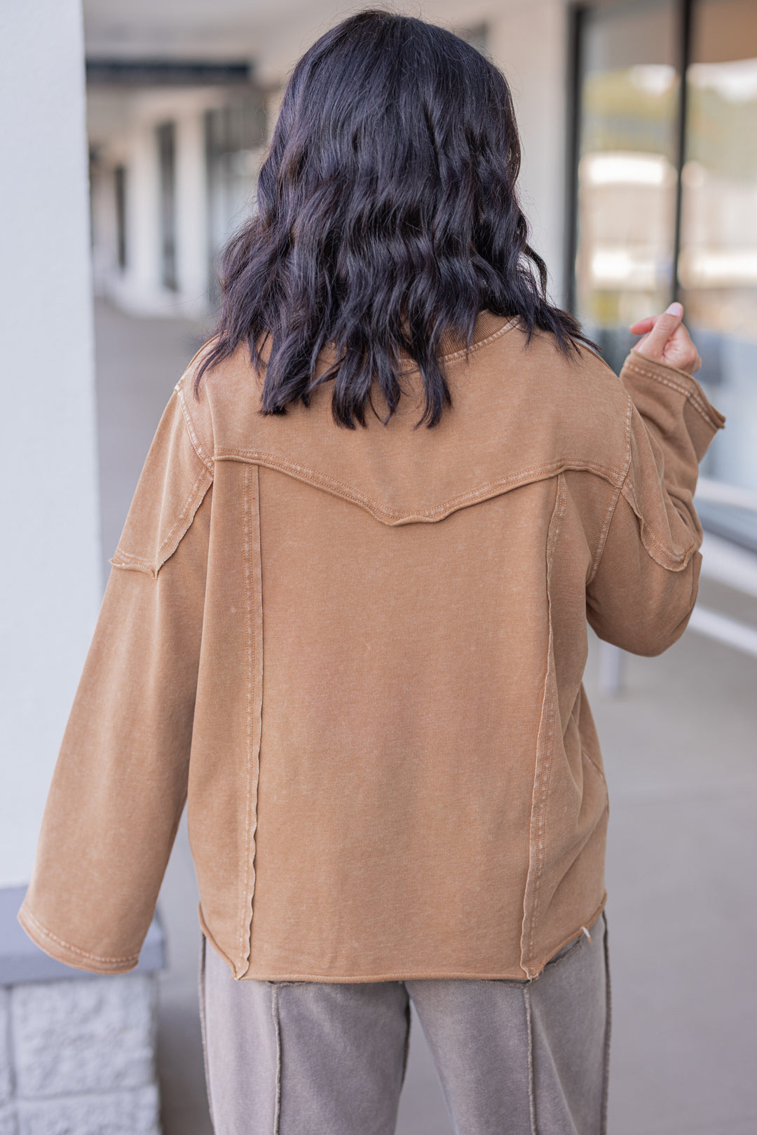 Women's mineral washed caramel terry knit pullover with raw/reverse seam details by Easel showing up close back view