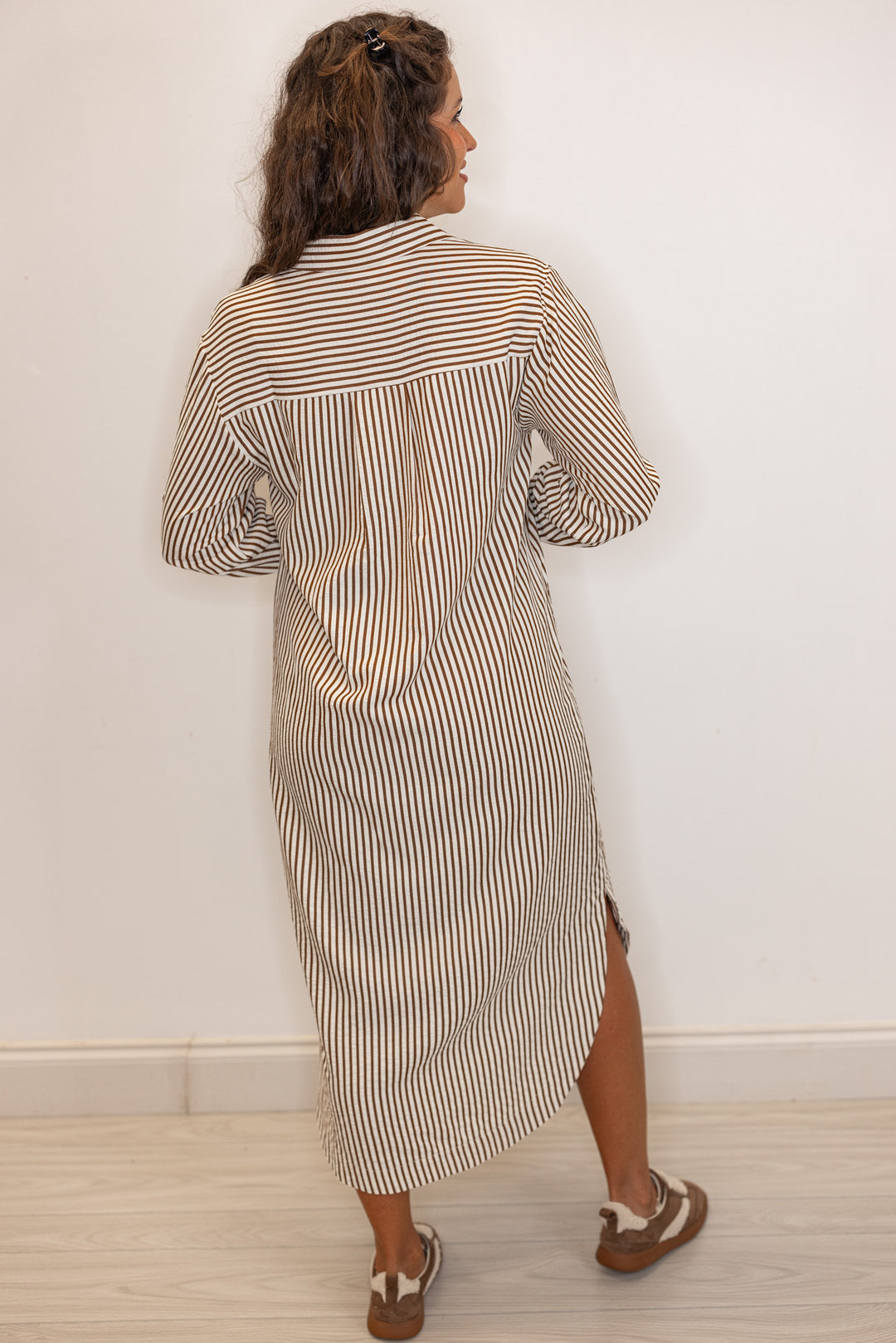 back view of Women's long sleeve caramel and ivory  striped maxi dress
