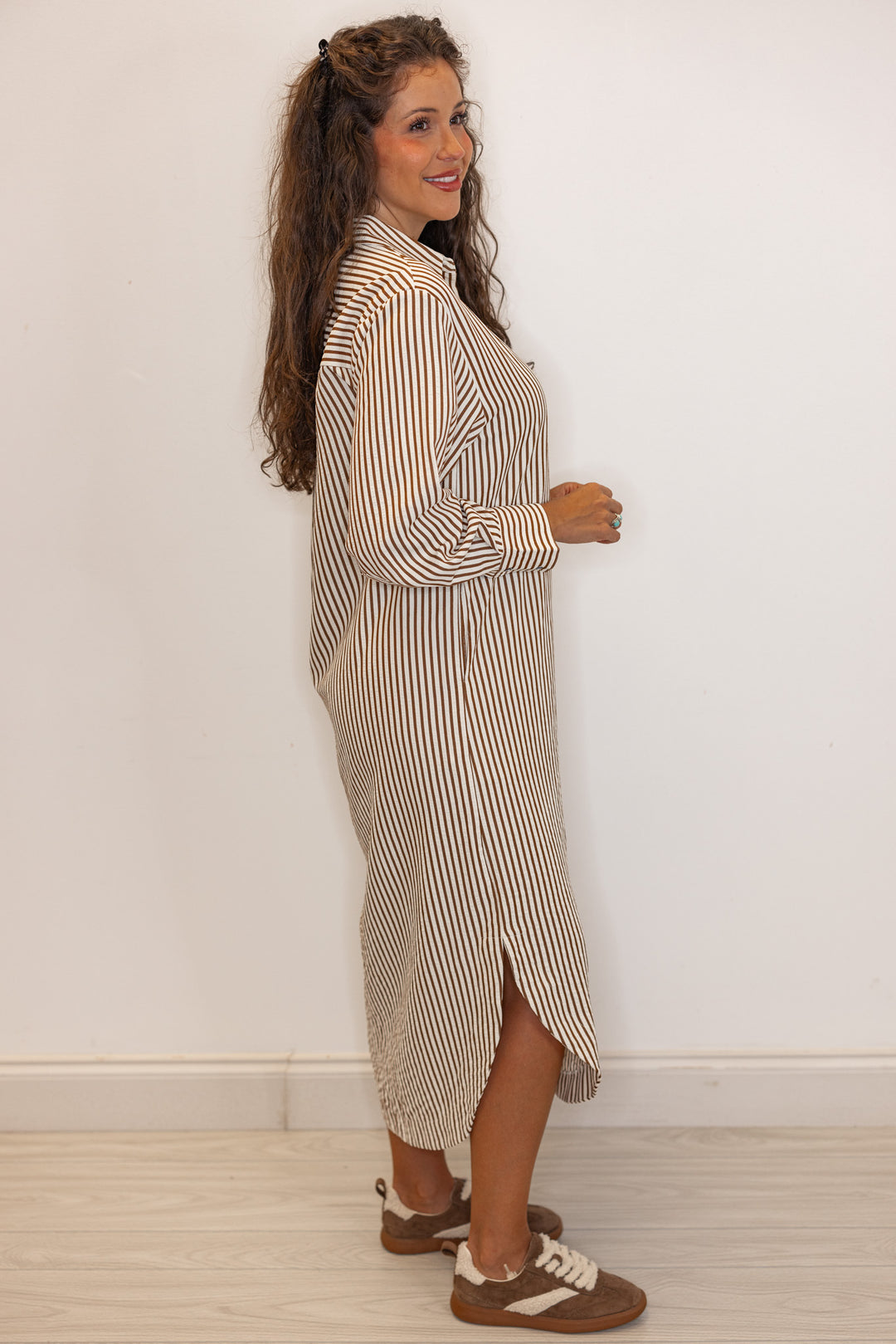 Side view of Women's long sleeve caramel and ivory  striped maxi dress