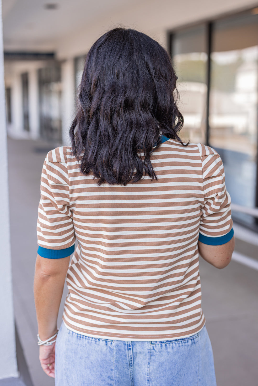 Women's tan striped knit textured top with dark turquoise trim by Entro showing up close back view