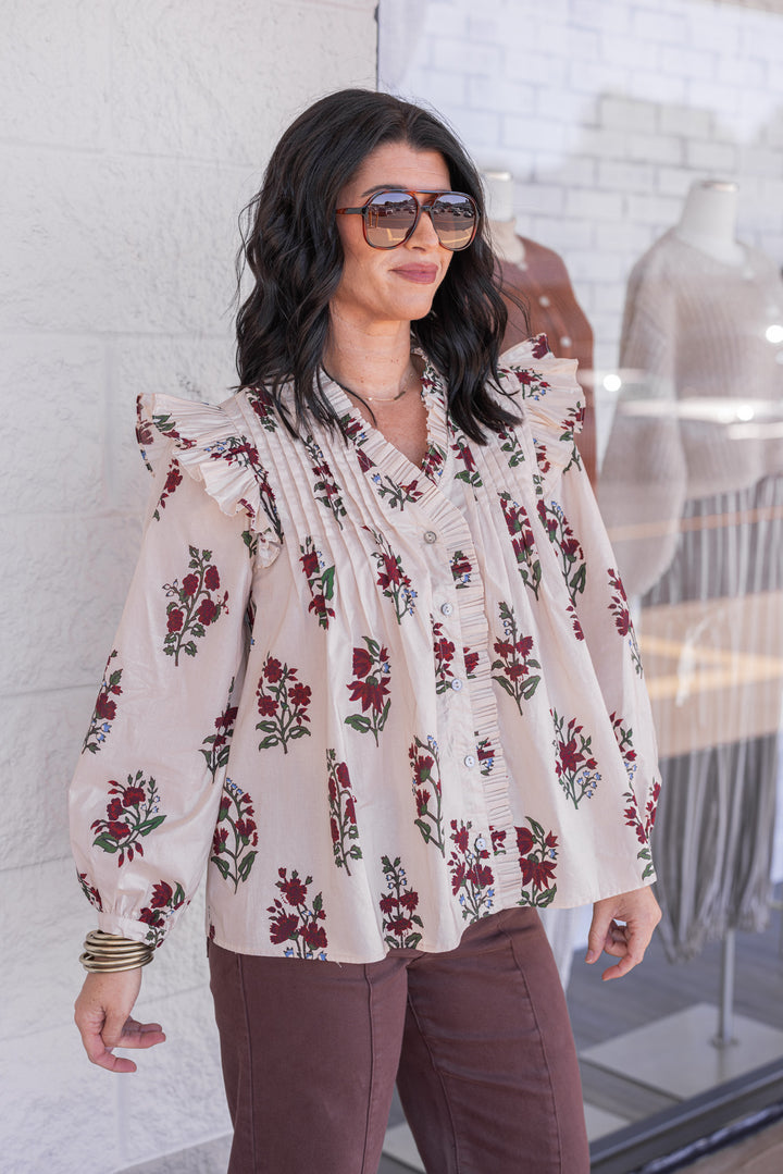 Women's ecru and burgundy floral print babydoll top with pleats and ruffle details by Entro showing slight side view