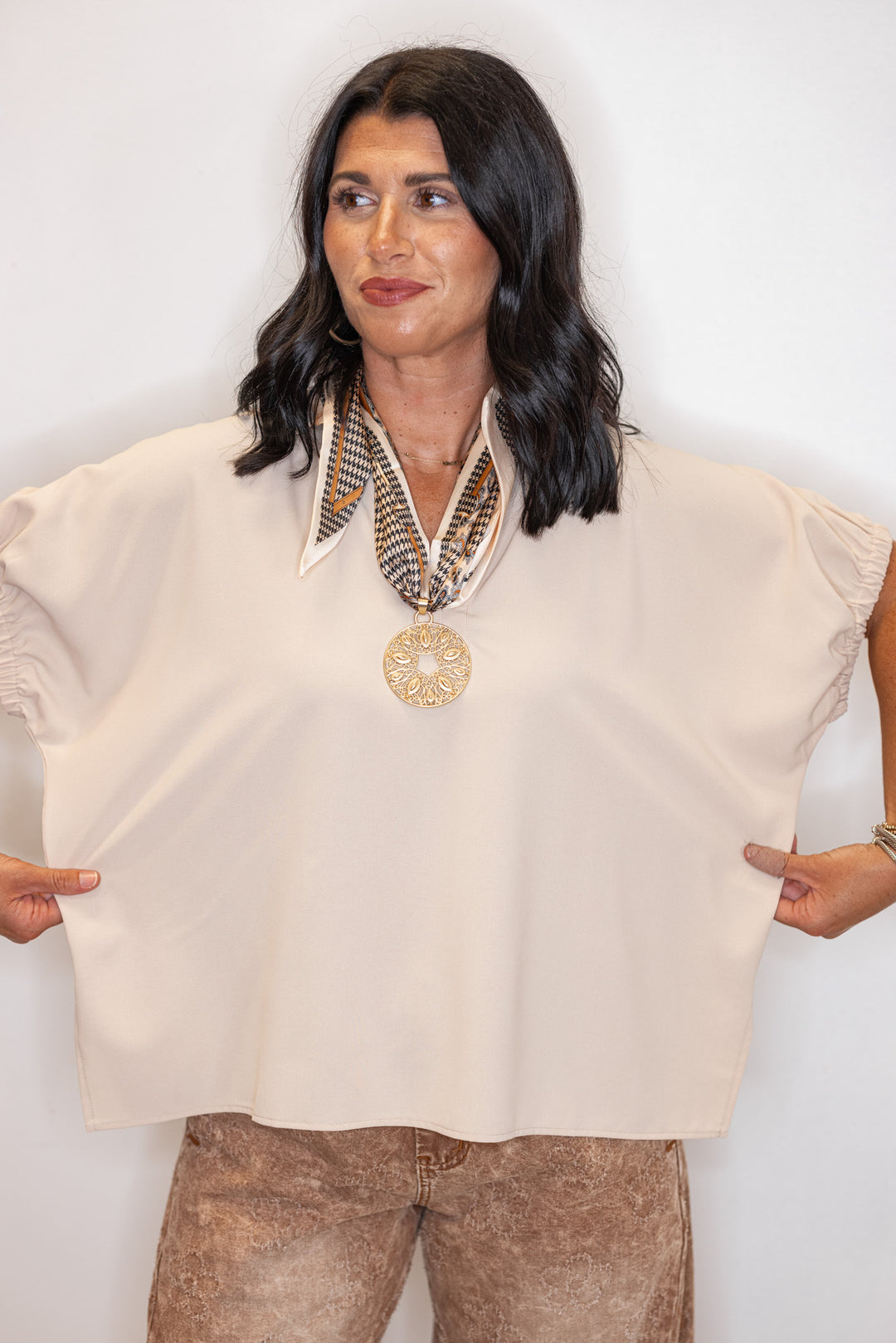 Women's ecru short sleeve top by Entro showing fabric's stretch