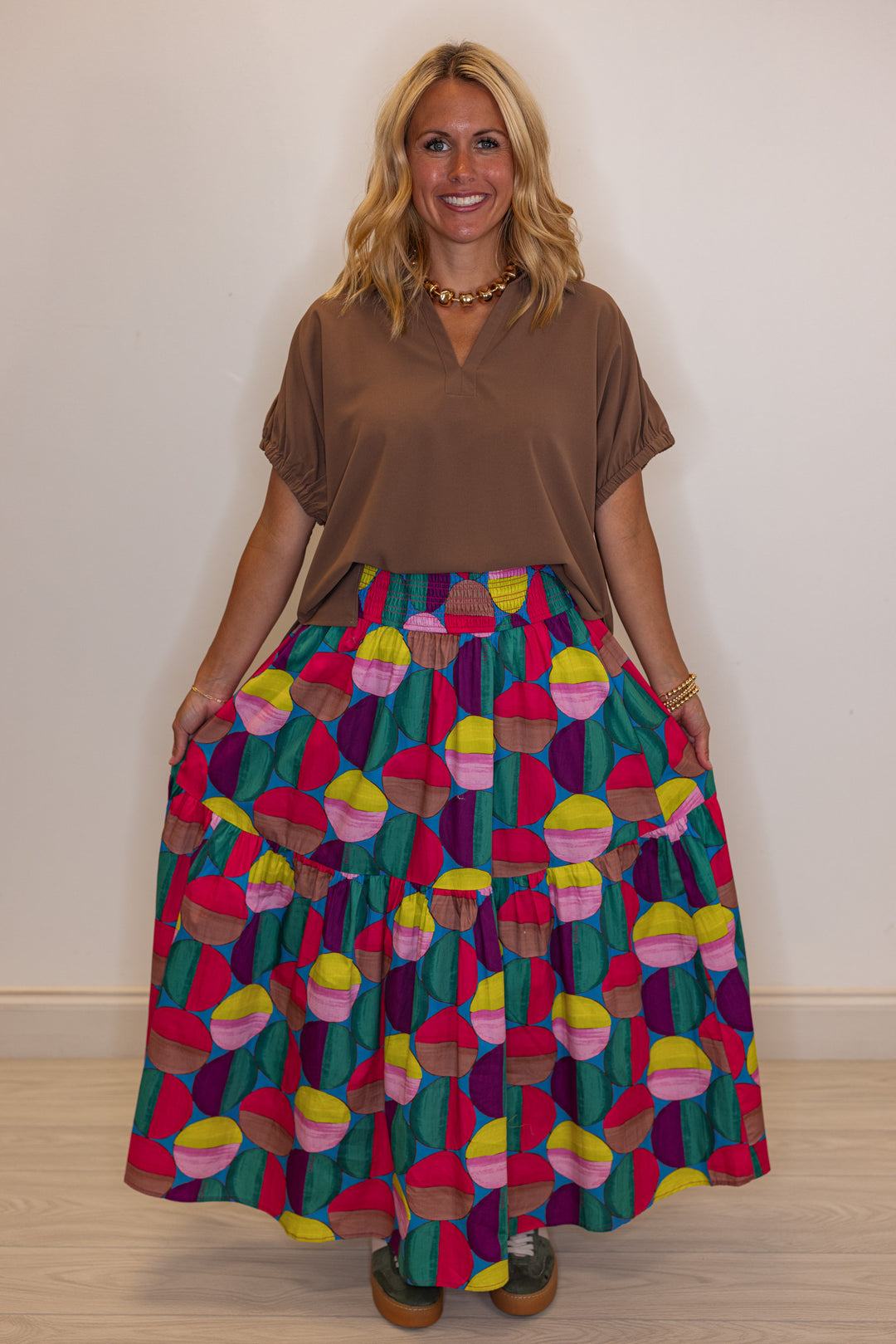 Women's smocked hot pink and multicolor print tiered poplin maxi skirt by Karlie showing relaxed, flowy fit
