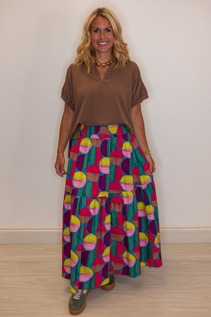 Women's smocked hot pink and multicolor print tiered poplin maxi skirt by Karlie showing full front view