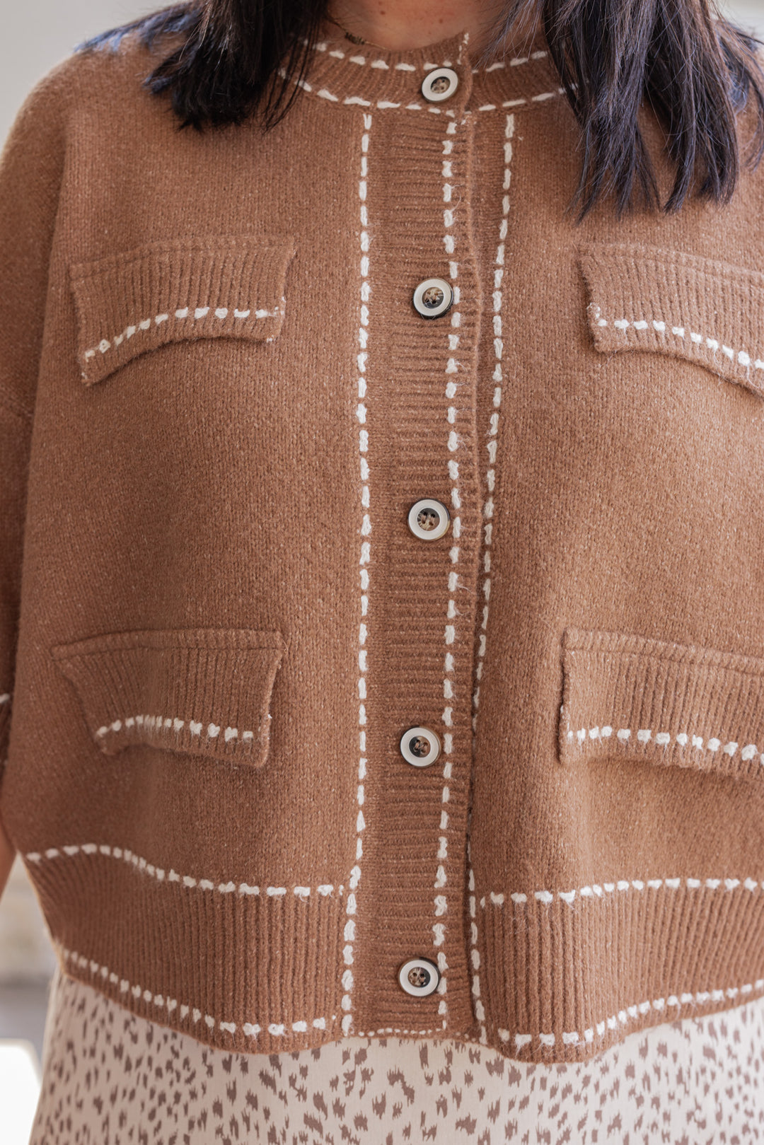 Women's caramel button front sweater cardigan with cream stitching detail by Entro showing up close front view