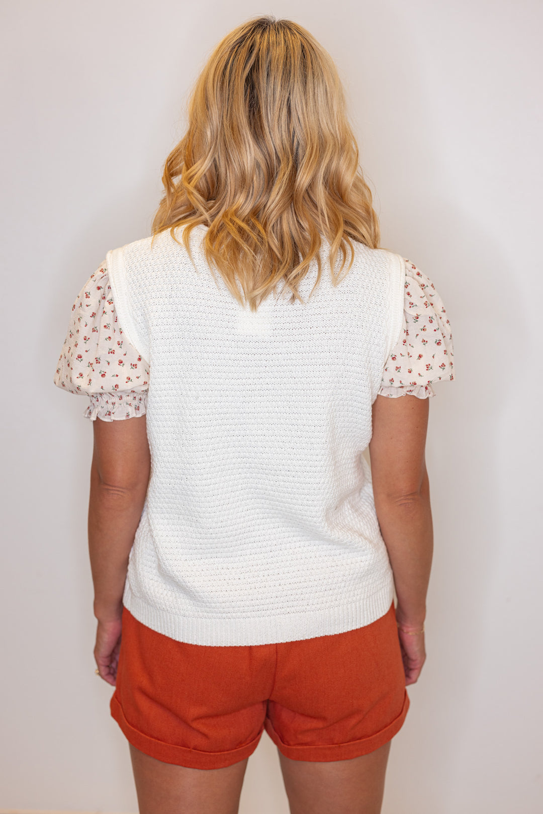 Cream lightweight textured sweater knit top with red floral print puff sleeves by Wishlist showing back view