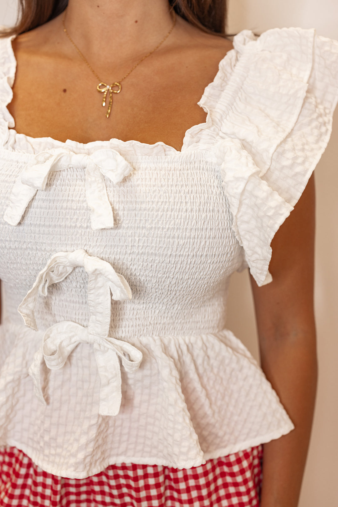 white smocked ruffle bow peplum top