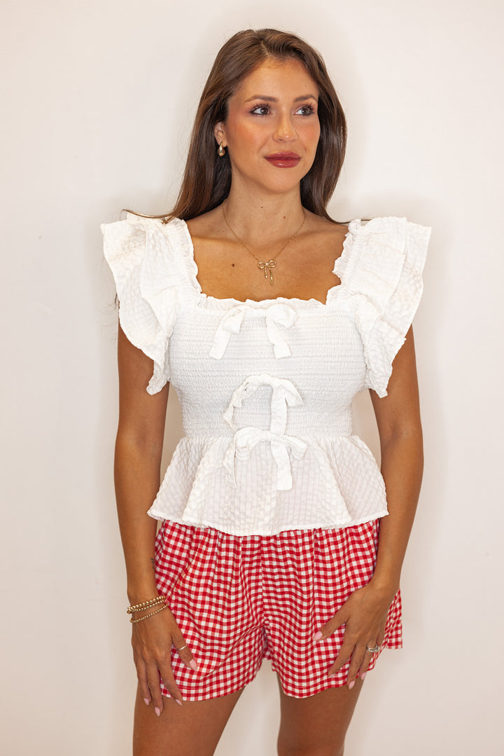 white smocked ruffle bow peplum top