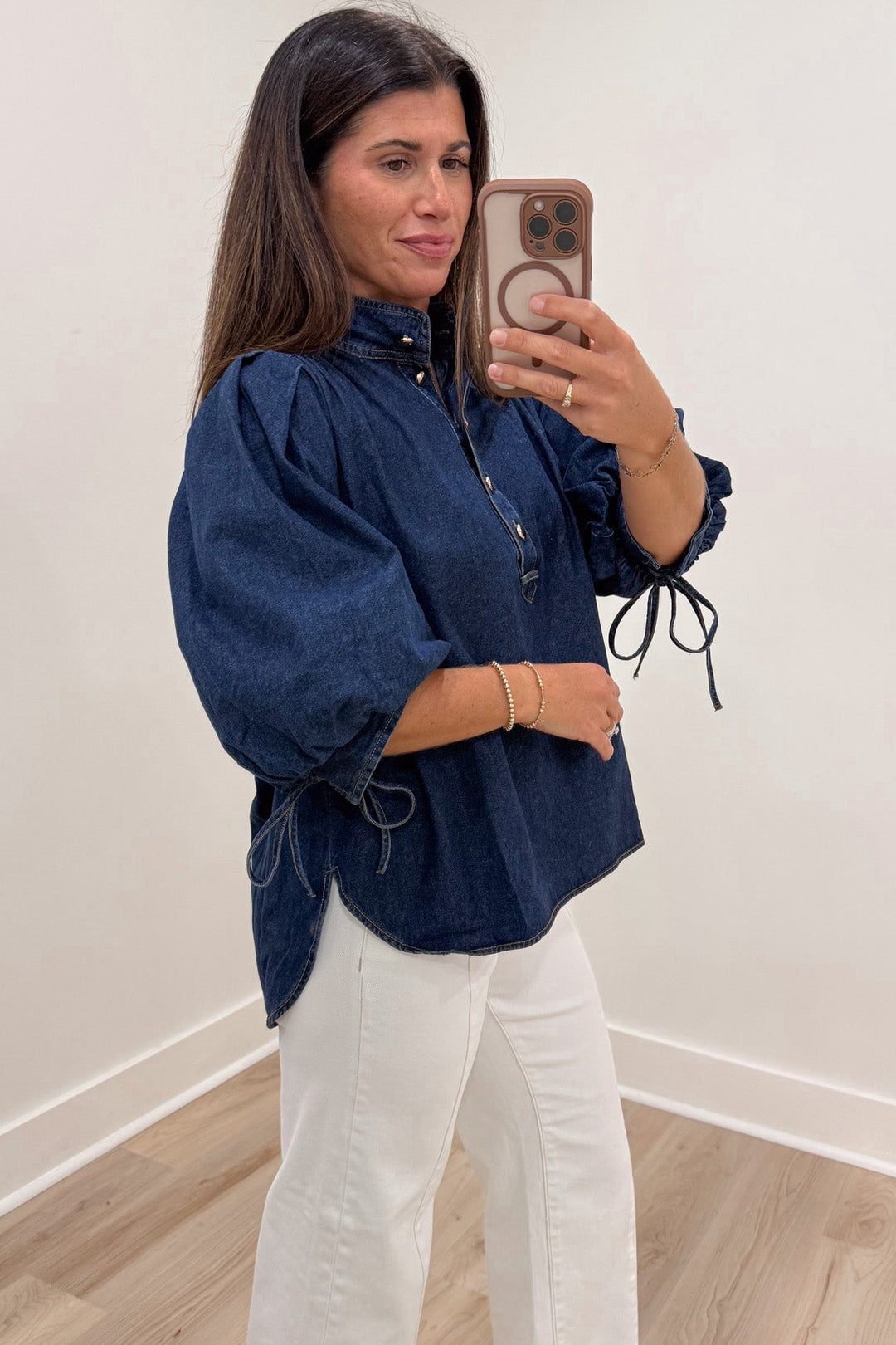 solid dark blue denim self-tie cuffed 3/4 length puff sleeve mock neckline button front bodice top