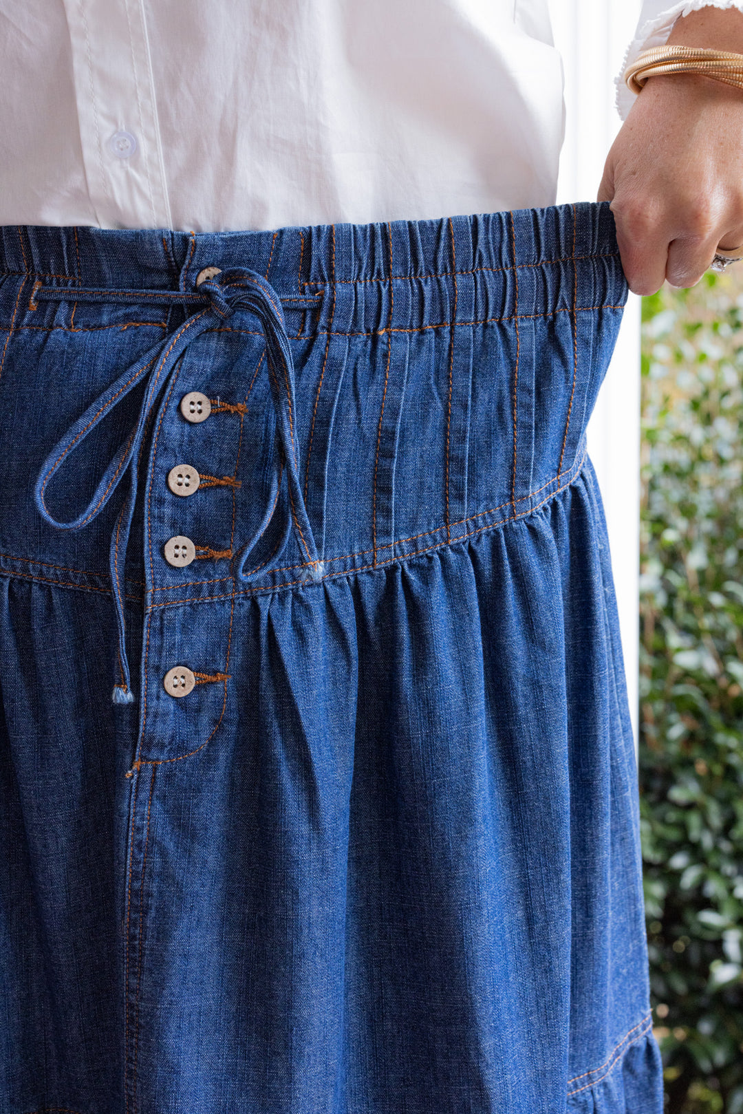 Dark denim maxi skirt by Peach Love California showing elastic waistband