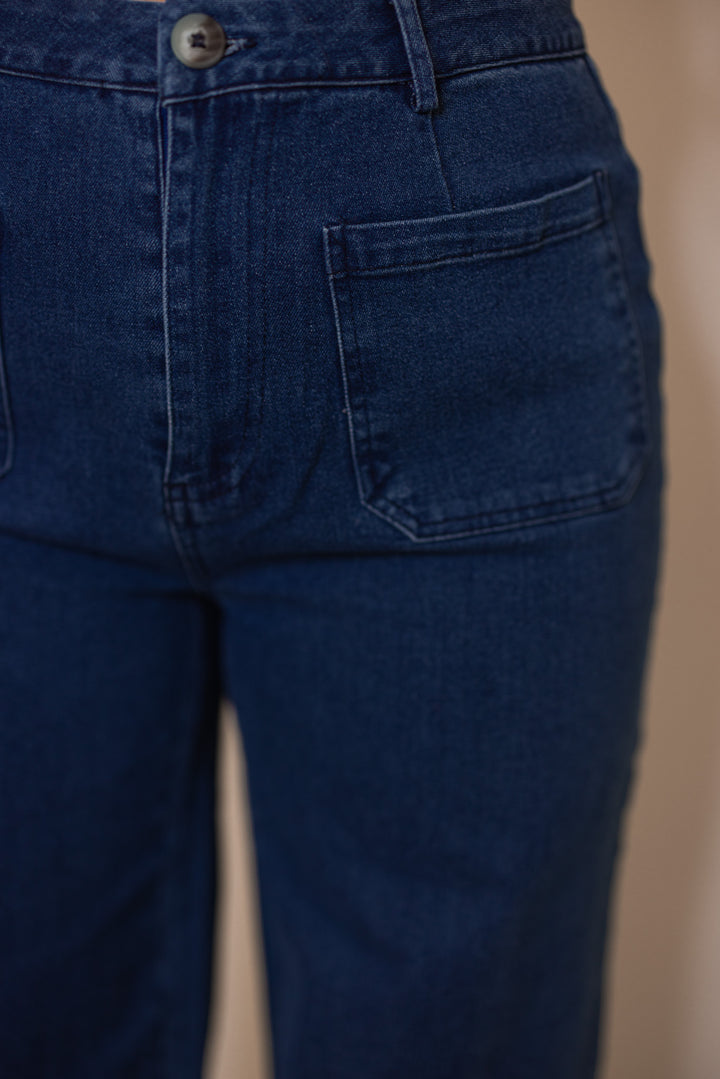 Women's dark washed blue denim wide leg jeans by Entro showing trendy front pockets