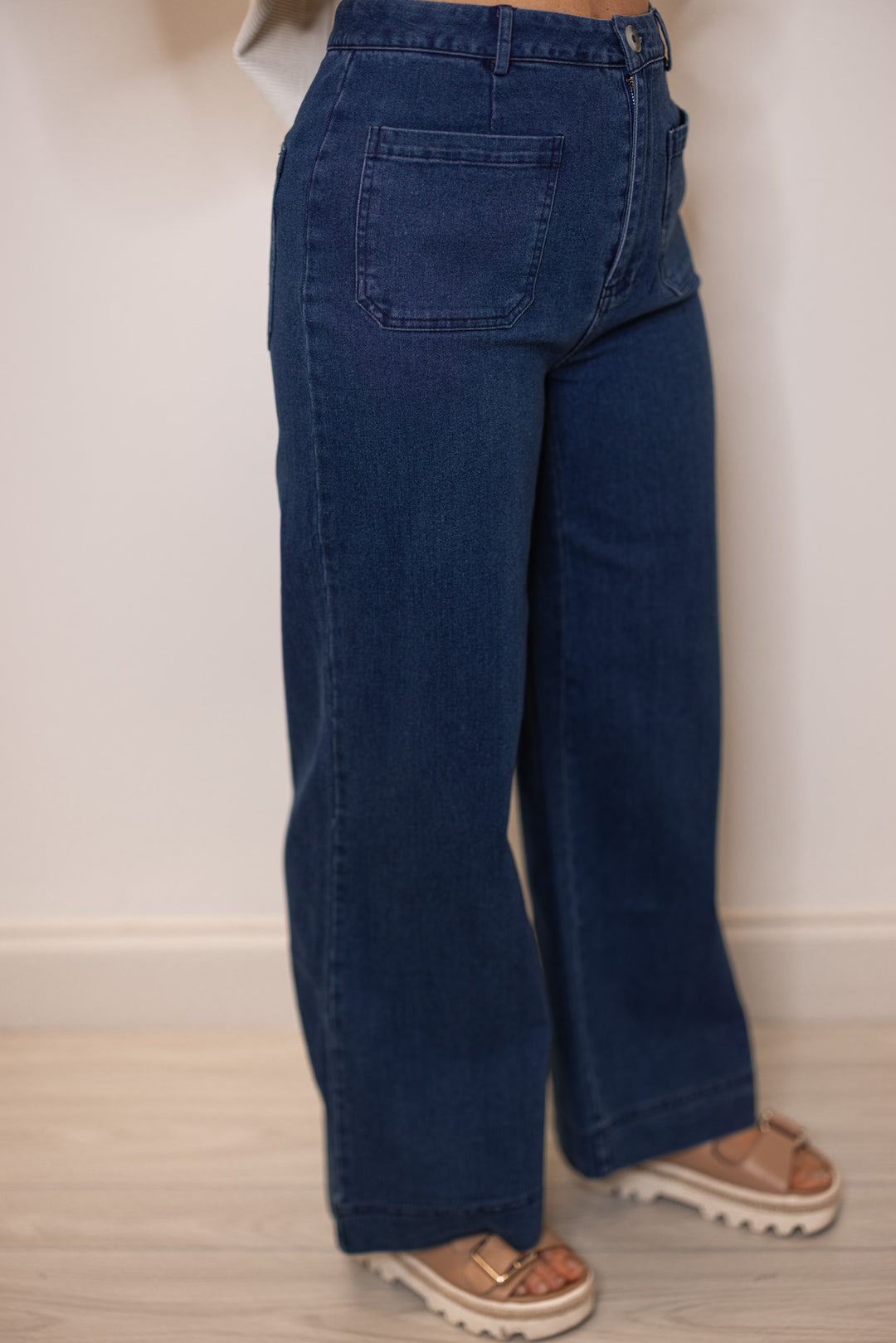 Women's dark washed blue denim jeans by Entro showing flattering wide leg fit