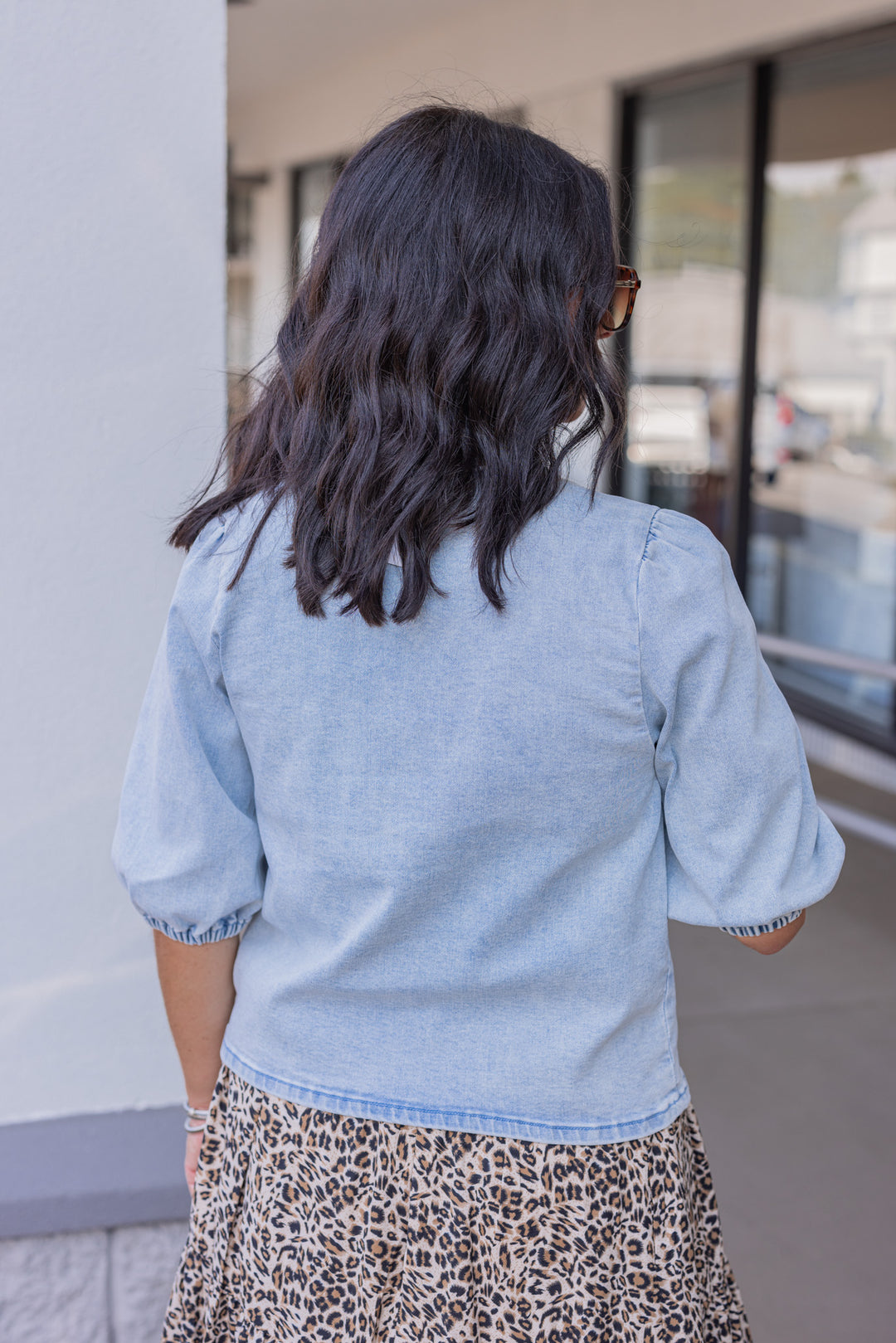 Blue denim top with bow tie closures down the open front peek a boo bodice by Wishlist showing up close back view