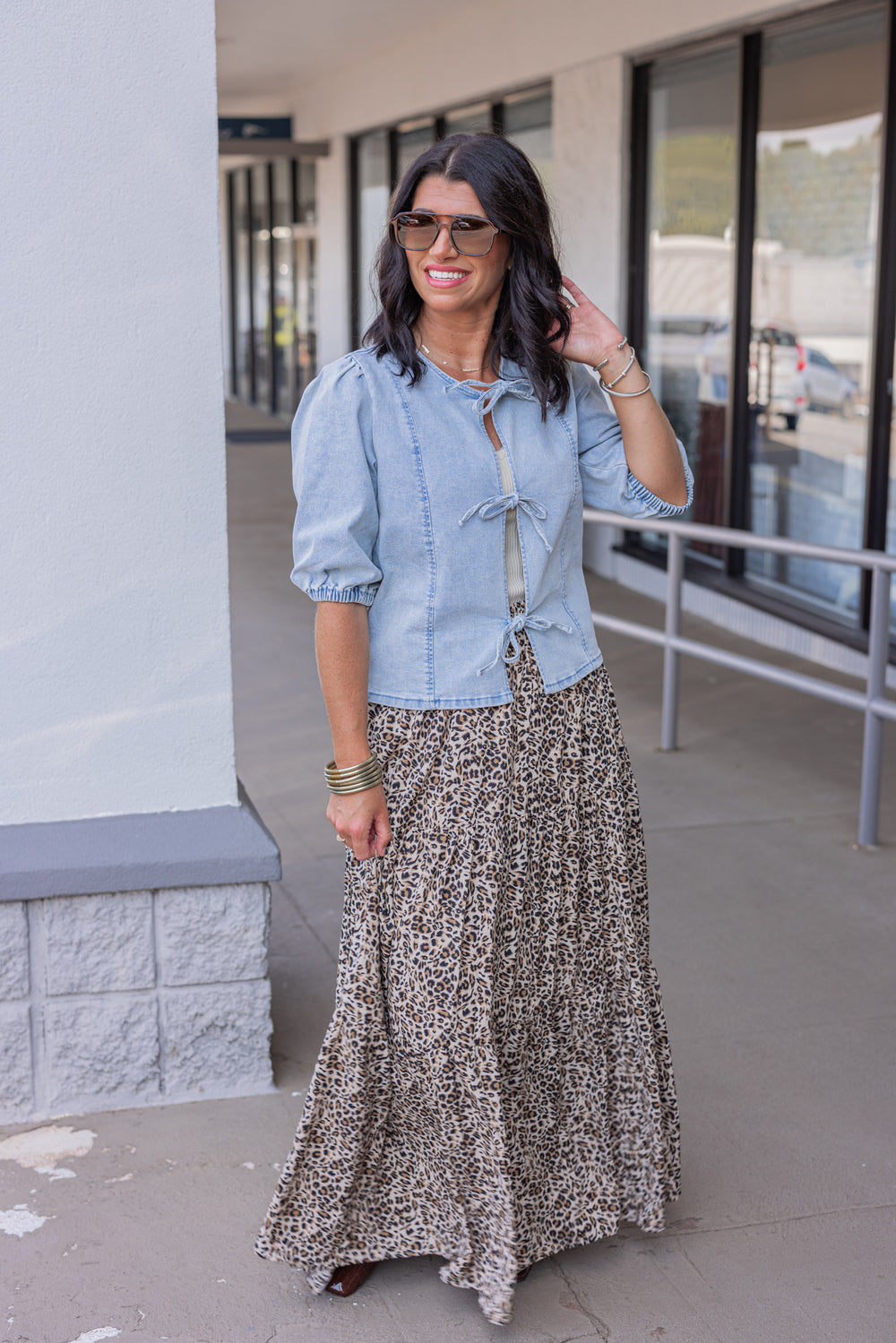 Blue denim top with bow tie closures down the open front peek a boo bodice by Wishlist showing full front view