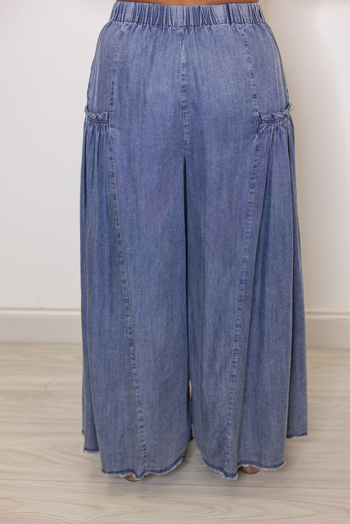 Palazzo style wide leg chambray denim pants in dark blue by Easel showing back view