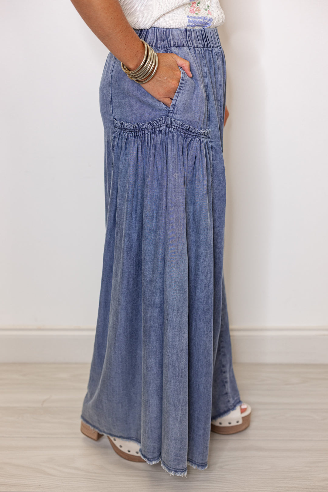 Palazzo style wide leg chambray denim pants in dark blue by Easel showing up close side view