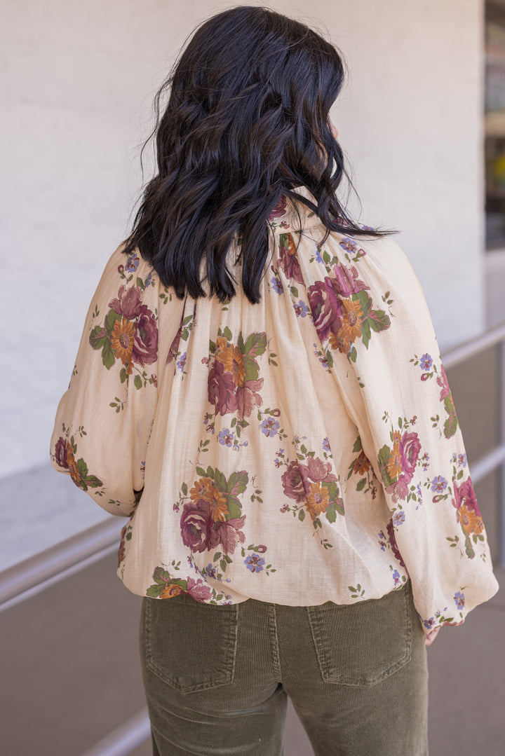 Women's ecru bubble hem top with large burgundy and olive floral print by Entro showing back view