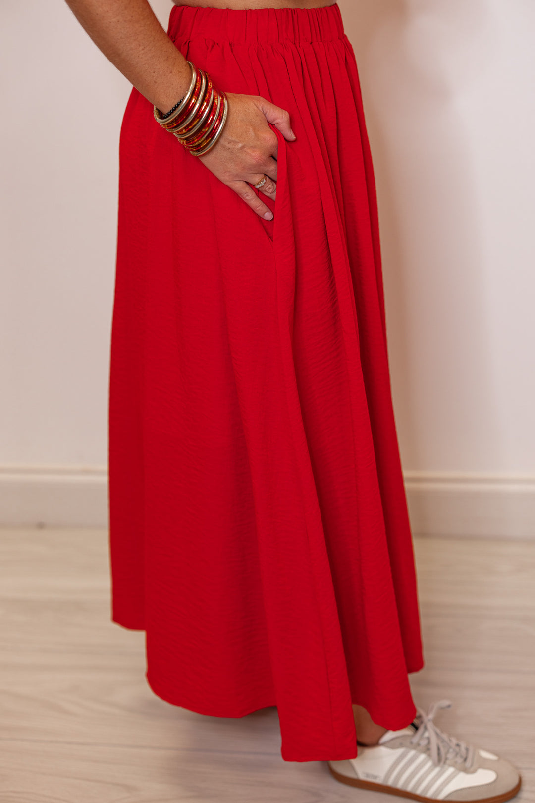 Women's red textured midi skirt with pleats by Entro showing up close side view