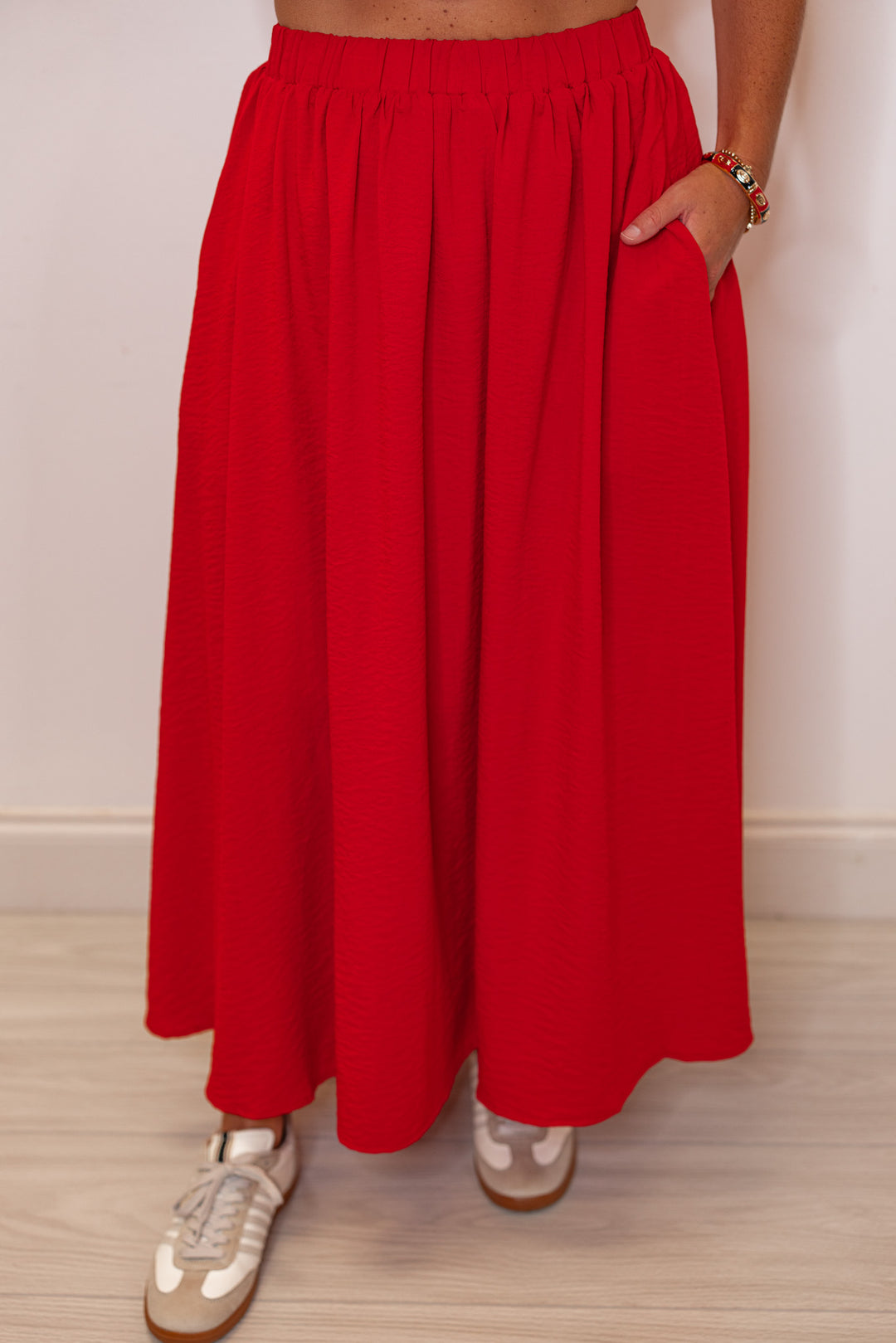 Women's red textured midi skirt with pleats by Entro showing up close front view