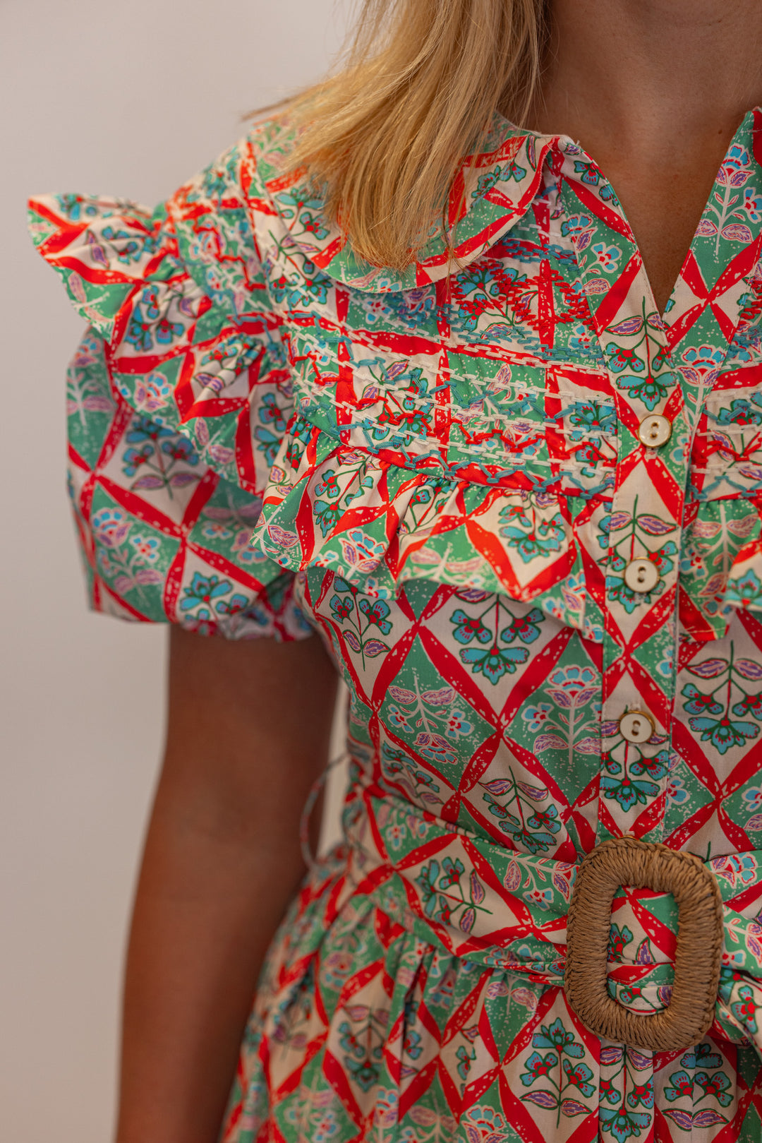 Women's green and coral pink floral print belted poplin maxi dress by Karlie showing up close view of floral pattern