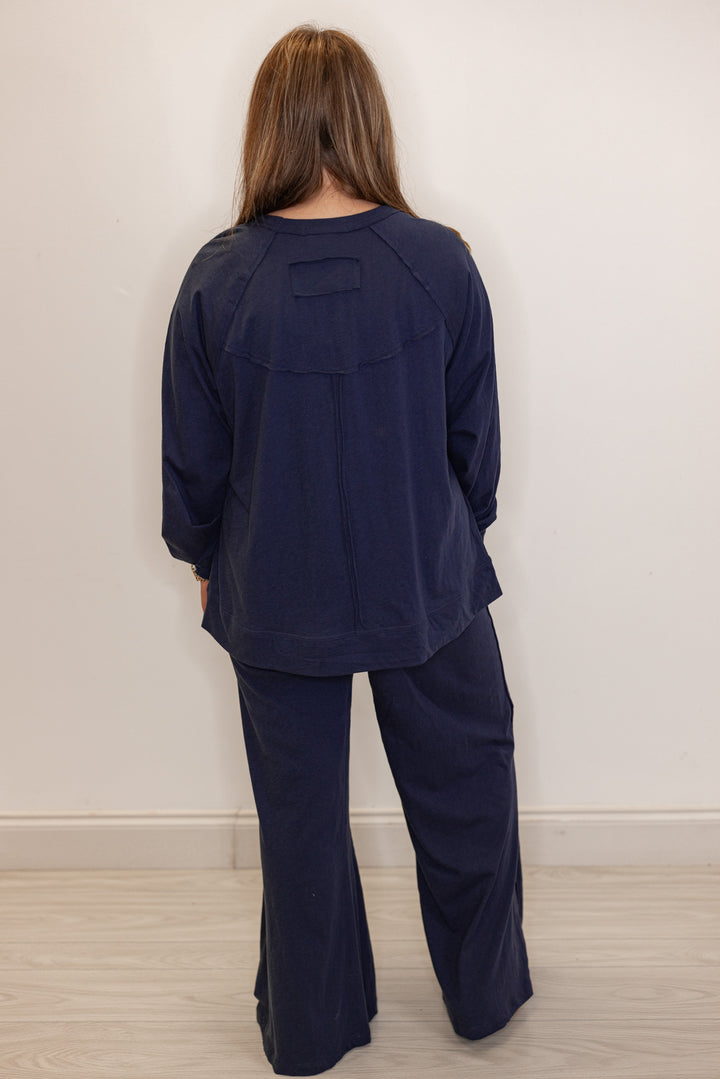 Back view of Women's navy blue athleisure long sleeve tee and pants set
