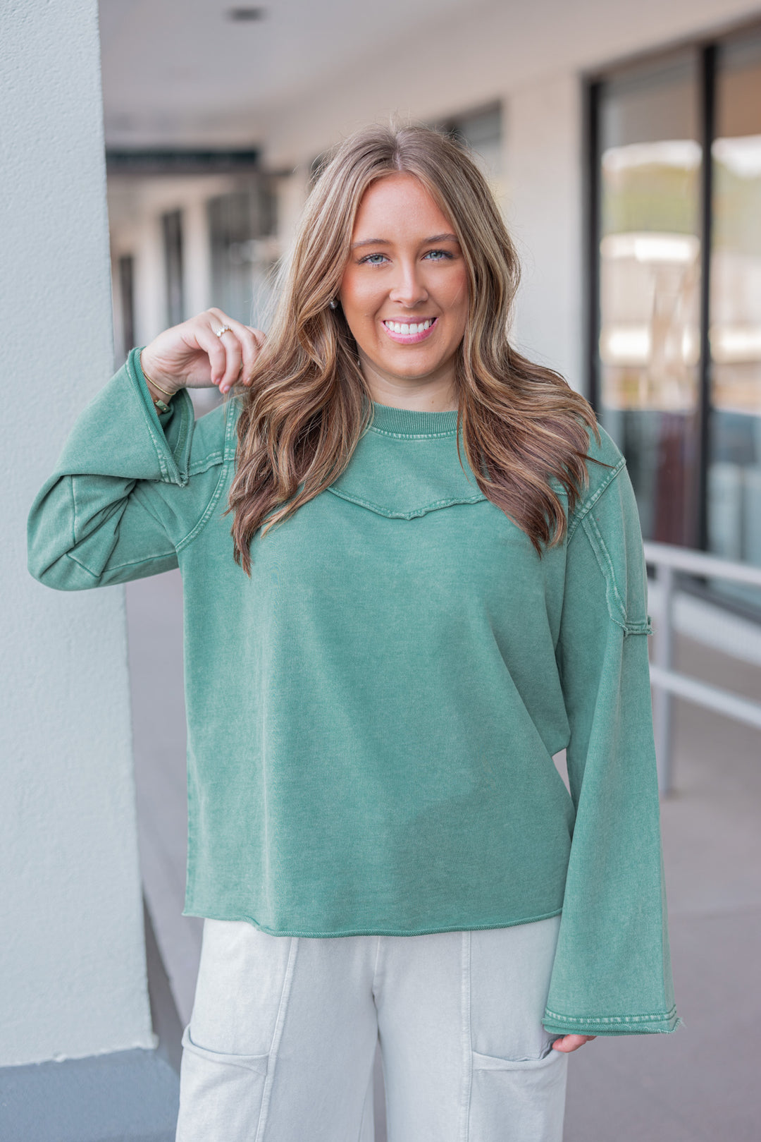 Women's mineral washed pine green terry knit pullover with raw/reverse seam details by Easel showing up close front view