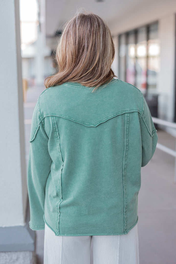 Women's mineral washed pine green terry knit pullover with raw/reverse seam details by Easel showing up close back view