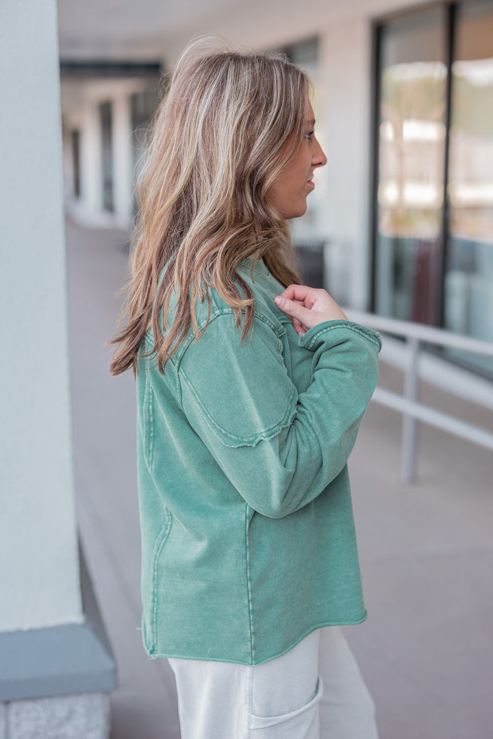 Women's mineral washed pine green terry knit pullover with raw/reverse seam details by Easel showing up close side view