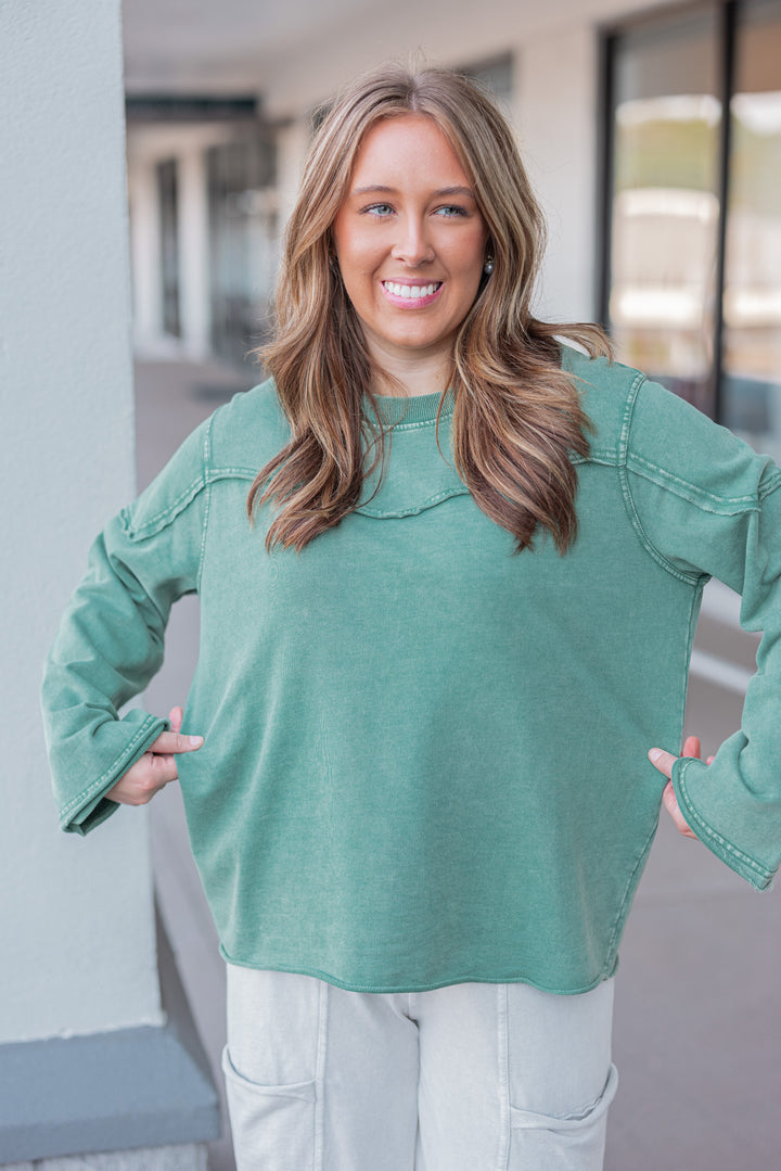 Women's mineral washed pine green terry knit pullover with raw/reverse seam details by Easel showing relaxed silouhette