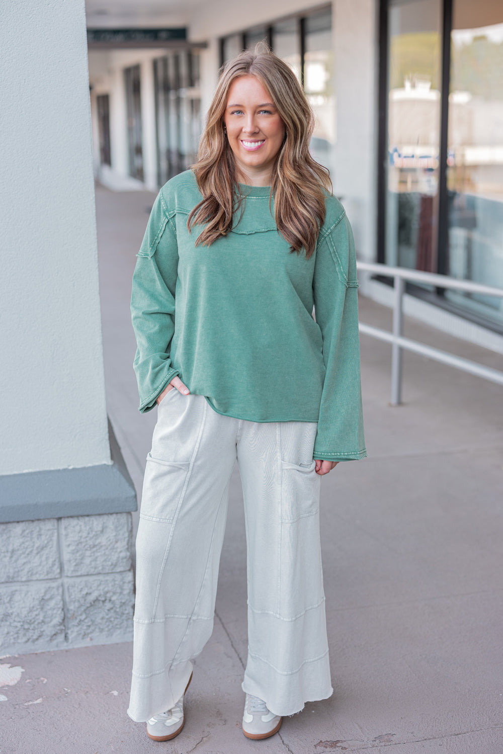 Women's mineral washed pine green terry knit pullover with raw/reverse seam details by Easel showing full front view