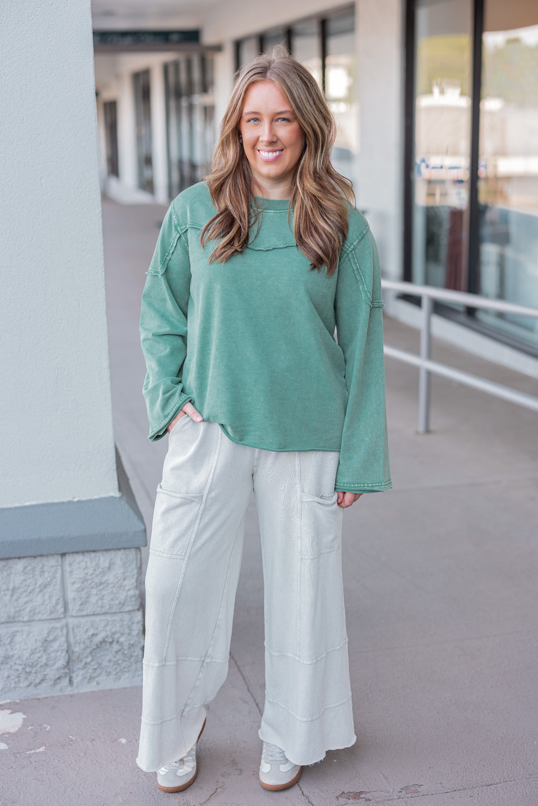 Women's mineral washed pine green terry knit pullover with raw/reverse seam details by Easel showing full front view