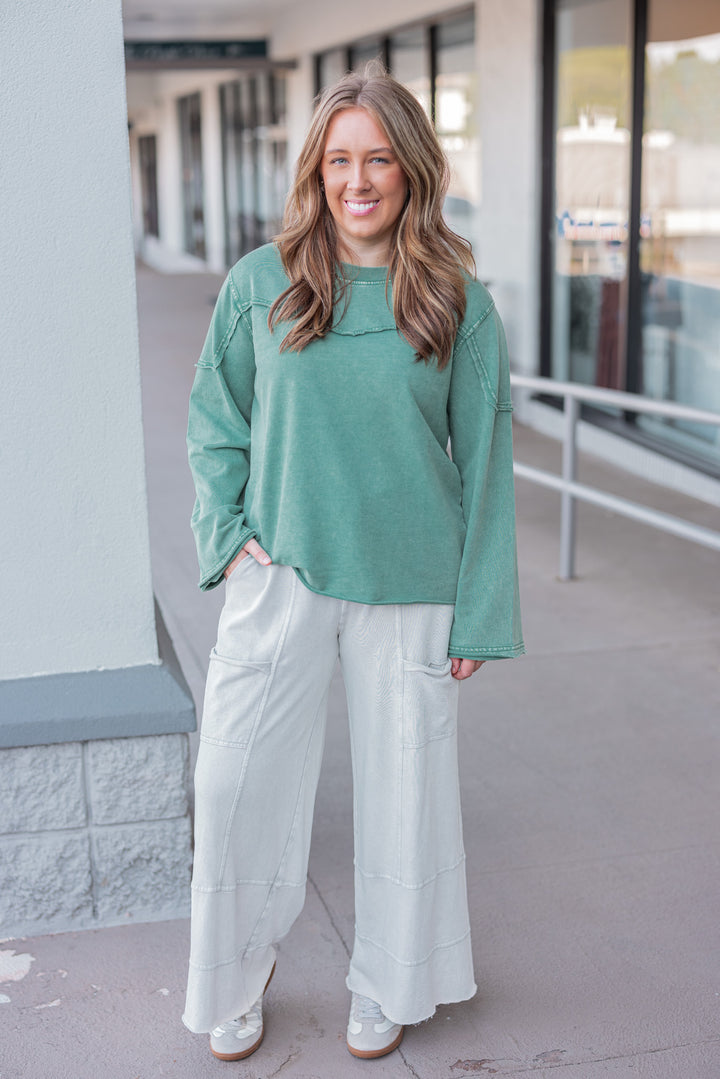 Women's mineral washed pine green terry knit pullover with raw/reverse seam details by Easel showing full front view