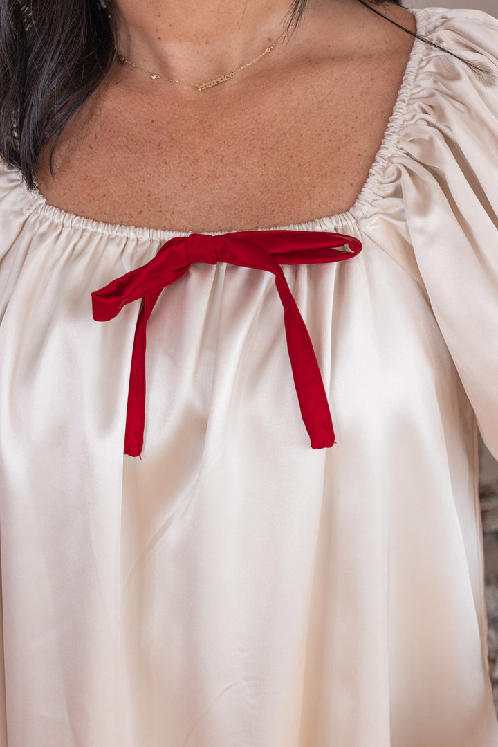 Women's cream dress with deep red ribbon bow tie detail by Wishlist showing square neckline with red bow detail