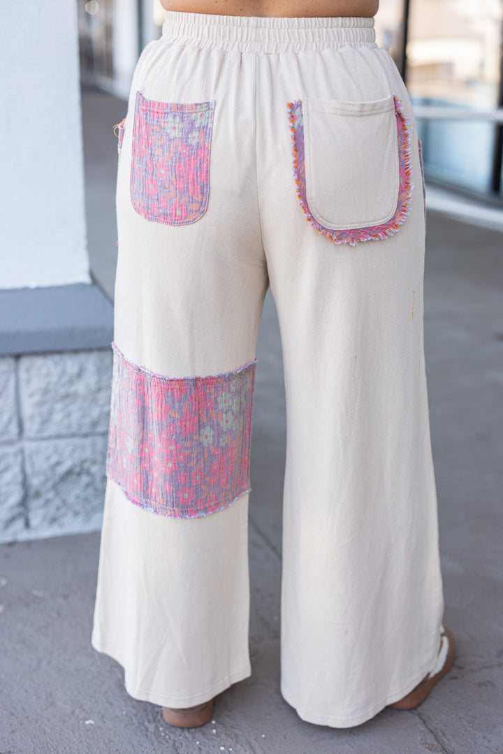 Women's french terry knit oatmeal pants with frayed floral patch gauze details by Easel showing back view