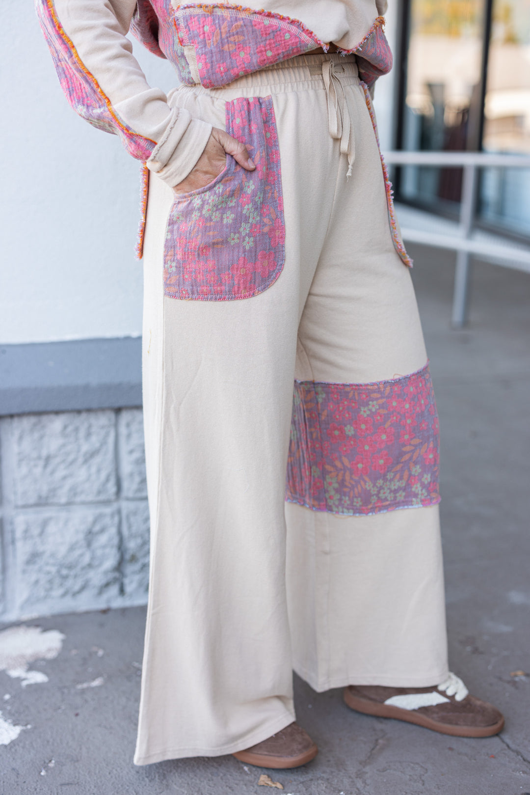 Women's french terry knit oatmeal pants with frayed floral patch gauze details by Easel showing side view