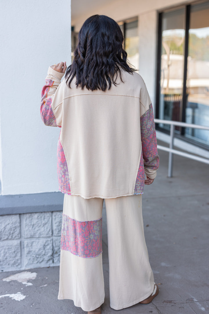 Women's french terry knit oatmeal pullover top with frayed floral patch gauze details by Easel showing full back view