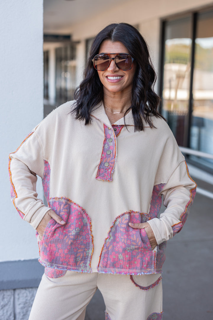 Women's french terry knit oatmeal pullover top with frayed floral patch gauze details by Easel showing front pockets