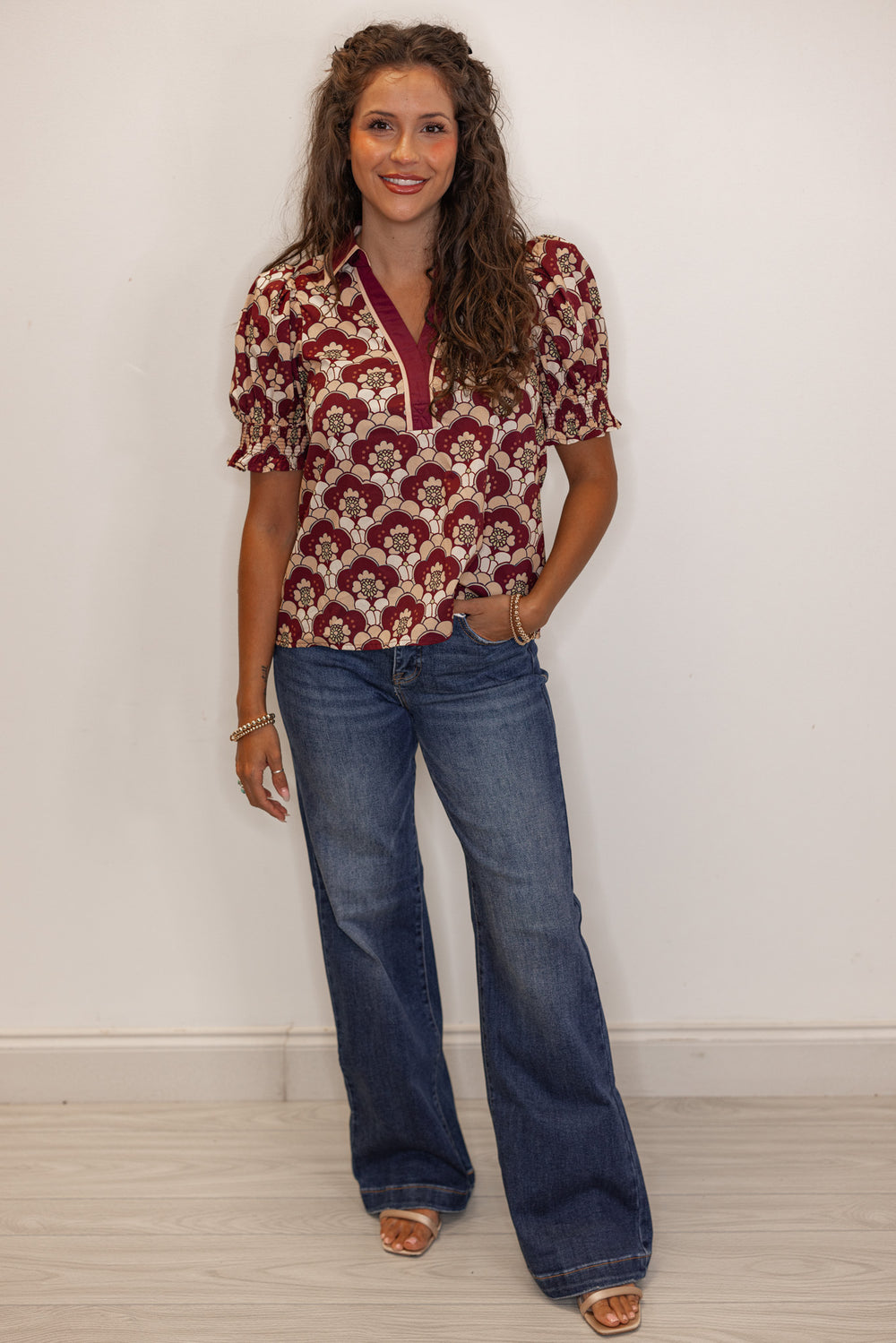 Short sleeve burgundy printed blouse paired with flare jeans